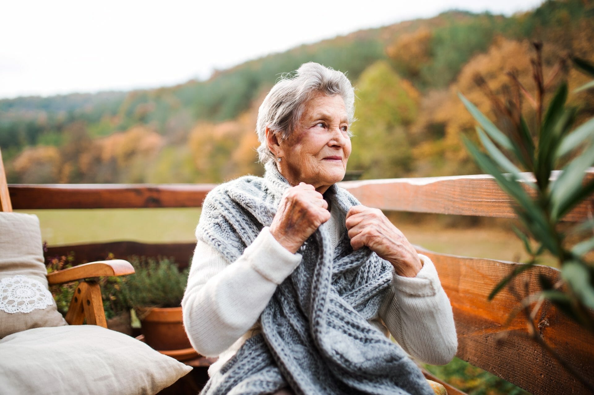 An Elderly Woman Sitting Outdoors On A Terrace concept representing the need for a tn living trust, revocable living trust tennessee, tn intestate succession, inheritance planning, tennessee wills, state of tennessee wills