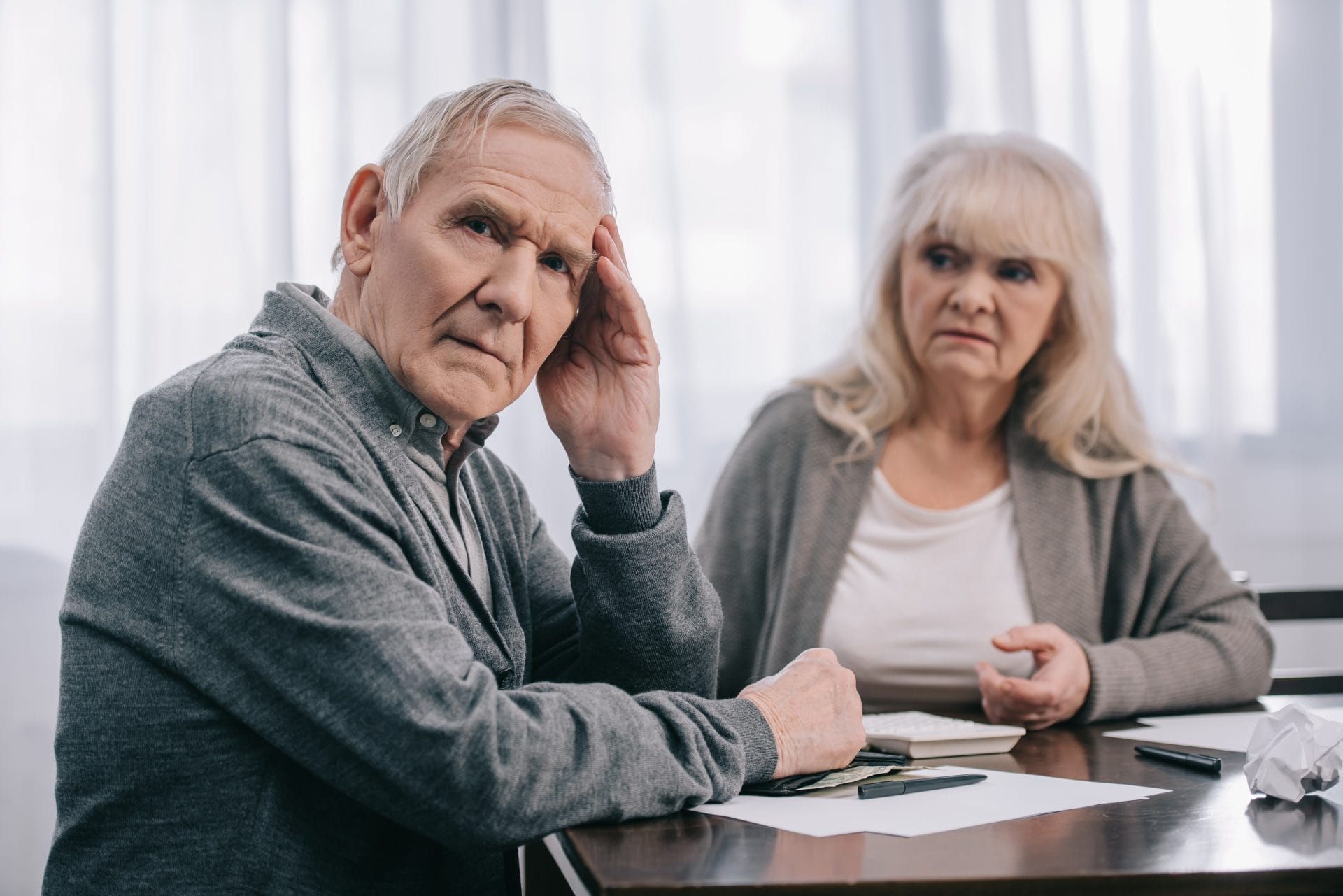 Senior Man With Hand On Head discussing last will and testament